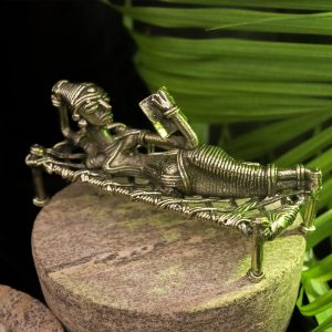 Dhokra Craft of a Tribal Woman Relaxing on Bed, Engrossed in a Book